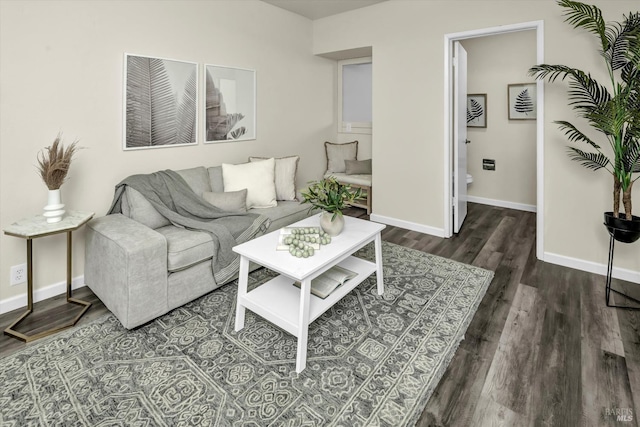 living room featuring dark wood-style flooring and baseboards