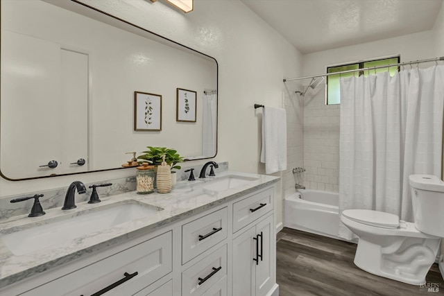 bathroom with shower / tub combo with curtain, a sink, toilet, and wood finished floors