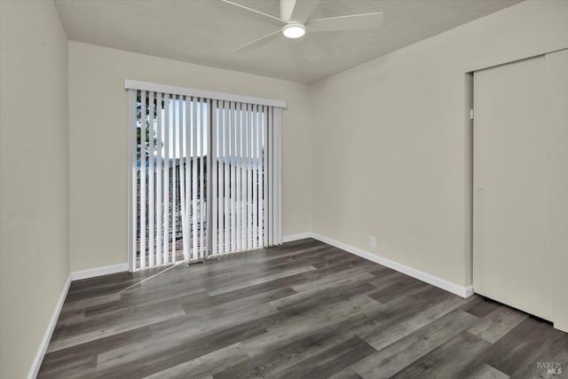 empty room featuring ceiling fan, a textured ceiling, and wood finished floors