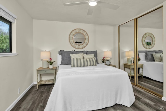 bedroom with a closet, dark wood-style flooring, baseboards, and a ceiling fan