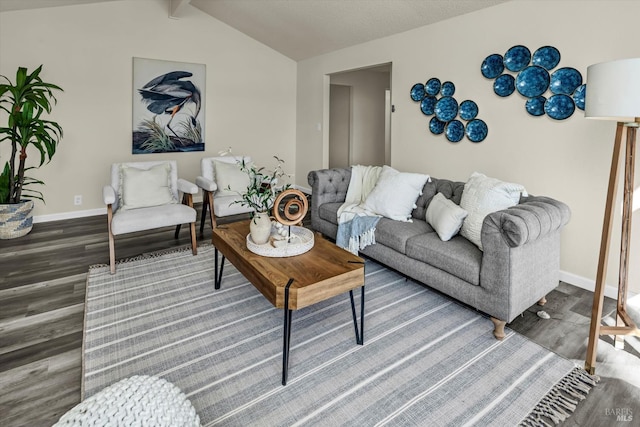 living area featuring vaulted ceiling with beams, baseboards, and wood finished floors