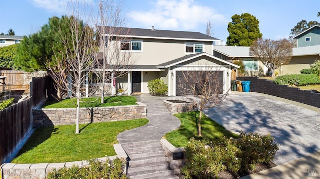 traditional home with stucco siding, concrete driveway, an attached garage, fence, and a front lawn