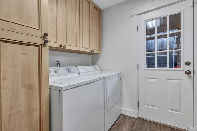 laundry room featuring baseboards, cabinet space, dark wood finished floors, and washing machine and clothes dryer