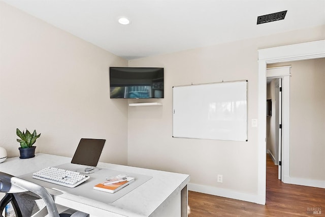 home office featuring visible vents, baseboards, wood finished floors, and recessed lighting