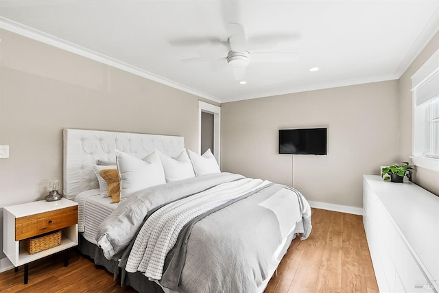 bedroom with a ceiling fan, baseboards, ornamental molding, and wood finished floors