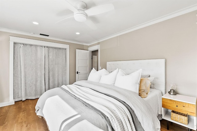 bedroom with baseboards, ceiling fan, wood finished floors, crown molding, and recessed lighting