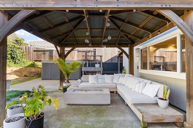 view of patio / terrace with outdoor lounge area, fence, and a gazebo