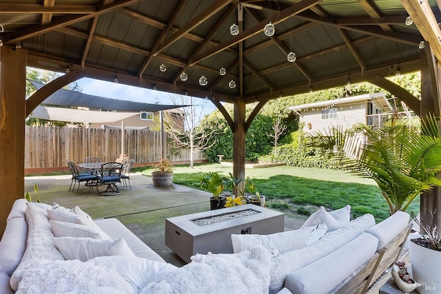 view of patio / terrace with a gazebo, fence, and an outdoor living space with a fire pit