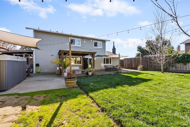 rear view of property featuring a patio area, a yard, a fenced backyard, and a gazebo