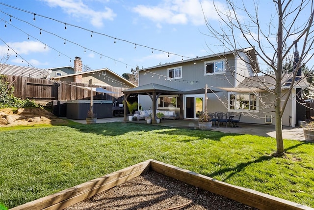 rear view of property with a jacuzzi, a fenced backyard, a yard, a gazebo, and a patio area