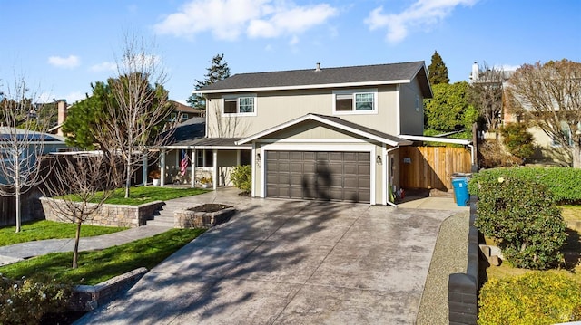 traditional-style house featuring driveway and fence