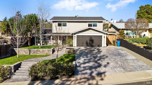 view of front of home featuring a garage, fence, a front lawn, and concrete driveway