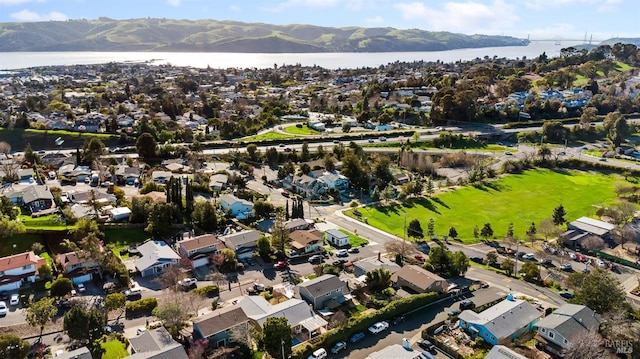 drone / aerial view featuring a residential view and a water and mountain view