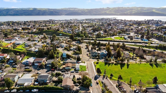 drone / aerial view featuring a residential view and a water and mountain view