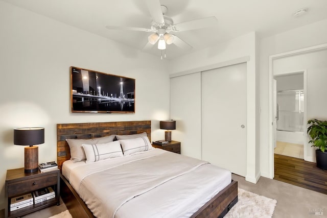 carpeted bedroom featuring a closet and a ceiling fan