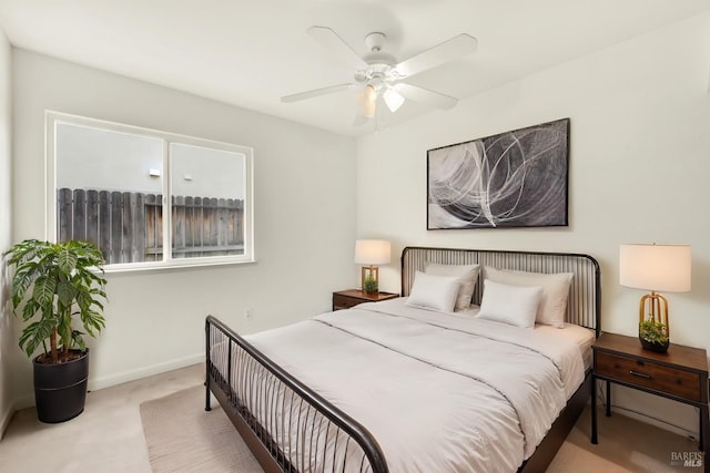 carpeted bedroom featuring a ceiling fan and baseboards