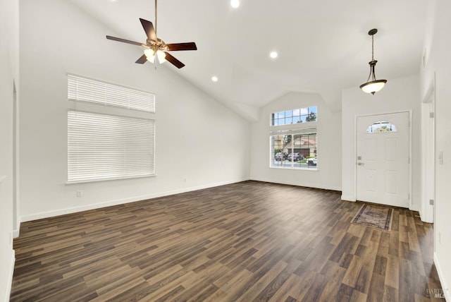 foyer entrance featuring recessed lighting, high vaulted ceiling, dark wood-type flooring, and baseboards