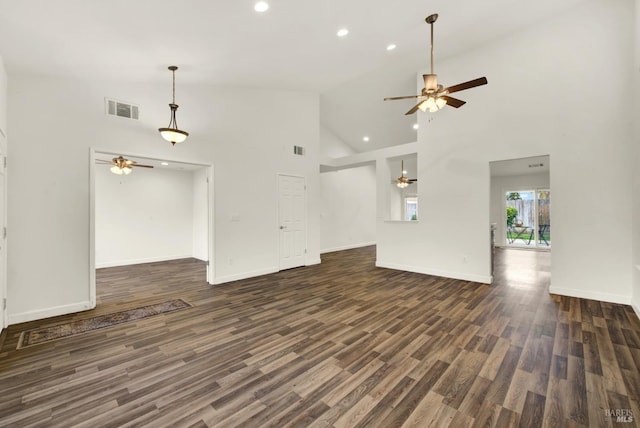 unfurnished living room with visible vents, dark wood-type flooring, and a ceiling fan