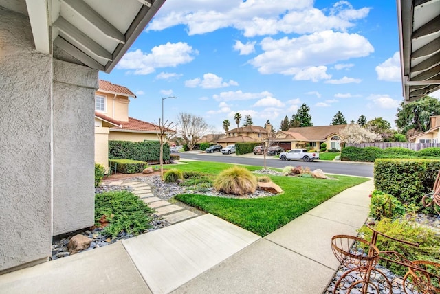 view of yard with a residential view and fence