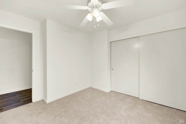 unfurnished bedroom with a closet, baseboards, carpet, and ceiling fan