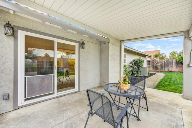 view of patio featuring central air condition unit and fence