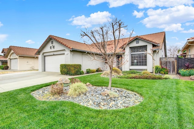 view of front of home featuring fence, concrete driveway, a front lawn, a garage, and a tiled roof