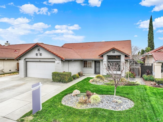 view of front of house featuring a tile roof, a front lawn, concrete driveway, and a garage