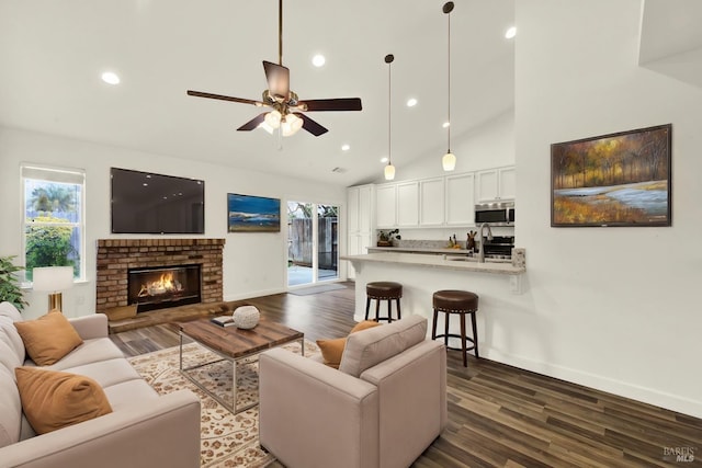 living area featuring a wealth of natural light, high vaulted ceiling, and dark wood-type flooring