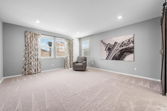 sitting room with carpet flooring, recessed lighting, and baseboards