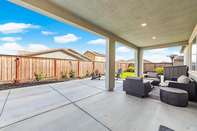 view of patio / terrace with an outdoor living space and a fenced backyard