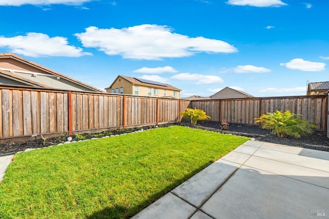 view of yard featuring a patio area and a fenced backyard