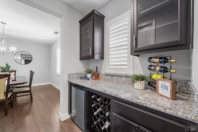 bar featuring wine cooler, refrigerator, dark wood-style flooring, visible vents, and a dry bar