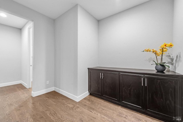 interior space with light wood-style floors and baseboards