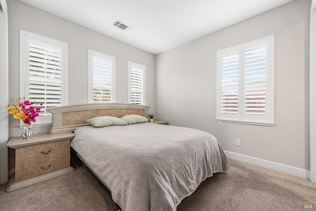 bedroom featuring carpet, visible vents, and baseboards