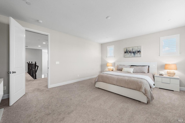 bedroom with carpet floors, multiple windows, and baseboards