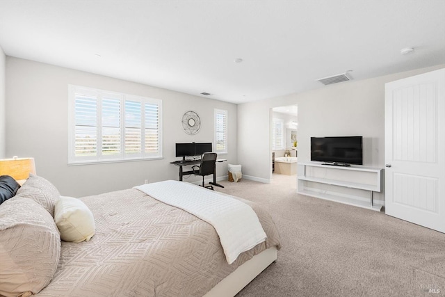 bedroom with carpet, ensuite bath, visible vents, and baseboards