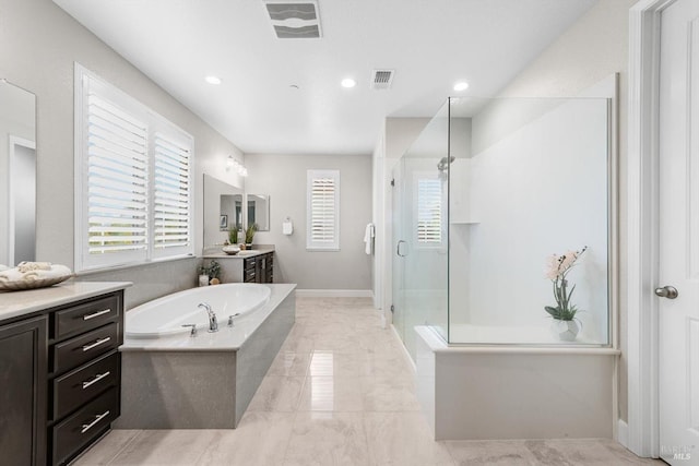 bathroom featuring a garden tub, a shower stall, visible vents, and vanity