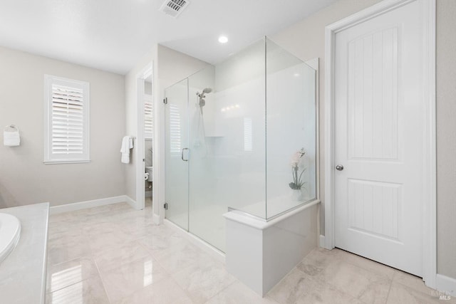 full bath featuring a stall shower, visible vents, and baseboards