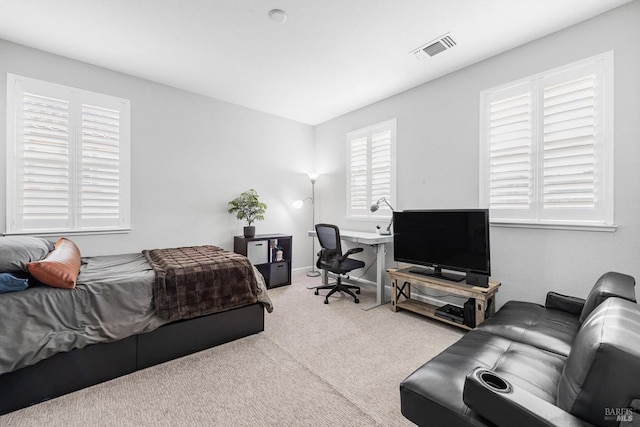 bedroom with carpet floors, visible vents, and baseboards