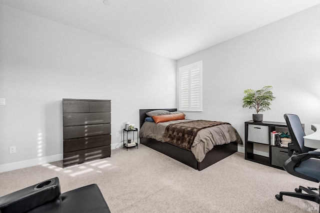 carpeted bedroom featuring baseboards