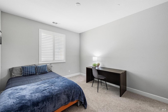 carpeted bedroom featuring baseboards and visible vents