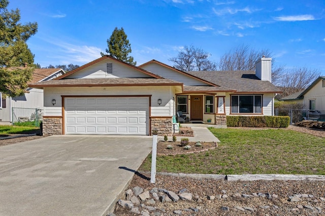 ranch-style home featuring concrete driveway, an attached garage, a front yard, fence, and stone siding