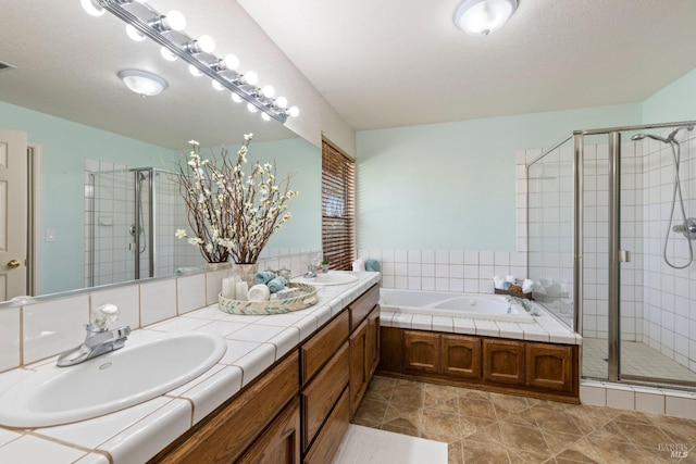 full bath with a stall shower, a garden tub, a sink, and double vanity