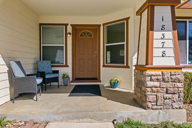 view of exterior entry featuring a porch