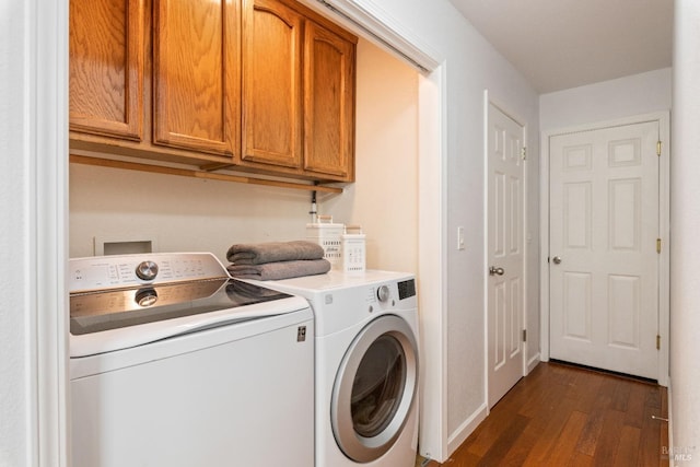 laundry area with dark wood-style flooring, cabinet space, and separate washer and dryer