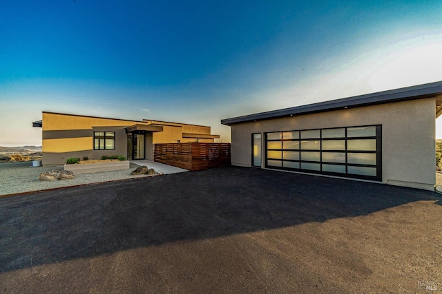 3400 Atlas Peak Rd, Napa, CA 94558 - contemporary home featuring a garage, an outdoor structure, fence, and stucco siding