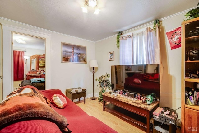 living area featuring ornamental molding and wood finished floors