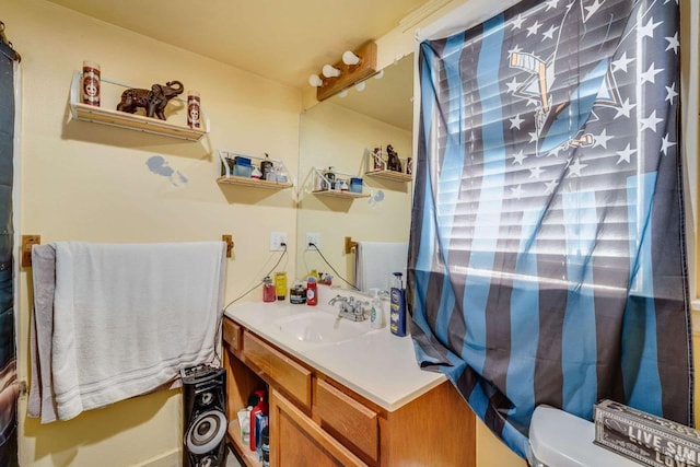 bathroom featuring toilet and vanity