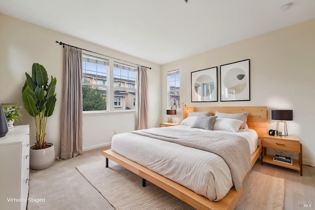 bedroom with multiple windows and baseboards