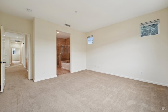 unfurnished bedroom with light carpet, visible vents, and baseboards